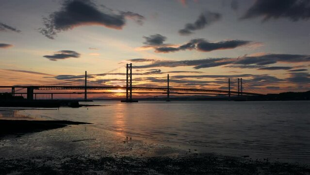 Aerial panoramic sunset view of Forth bridge in Scotland United Kingdom with scenic sky and dramatic clouds