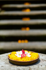 Sculpture of a temple with flowers and incense for ritual offerings on the popular tourist island of Bali.
