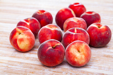 Fototapeta na wymiar Fresh juicy peaches on wooden background, harvest season