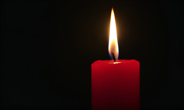One very short red candle near the bottom of the image burning in total darkness