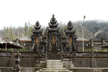 Fototapeta na wymiar The large sacred traditional temple of Pura Pasar Agung Sebudi on the mountain after the ash eruption at Mount Agung on the popular tourist island of Bali.