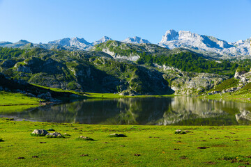 Serene landscape with one of Lakes of Covadonga and mountain range in summer day