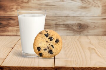 Plate with tasty sweet cookies and milk on table