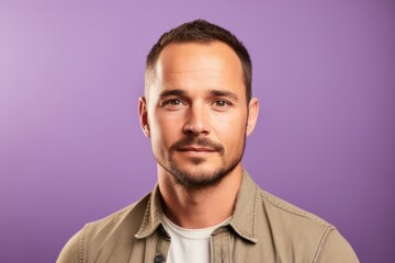 Portrait of a handsome young man on a purple background. Men's beauty, fashion.