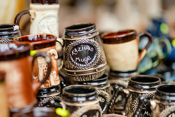 Ceramic dishes, tableware and jugs sold on Easter market in Vilnius. 'Kaziuko muge' means 'Kaziukas...