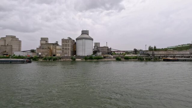 Factory Scene with Industrial Building and Equipment on the Rhine River. Large silo towers in the center of view.  Located just south of Mainz, Germany in Bleiau, Germany.