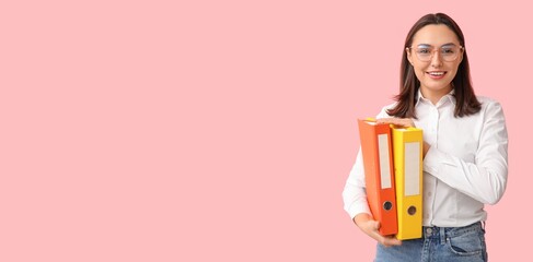 Young businesswoman with document folders on pink background with space for text