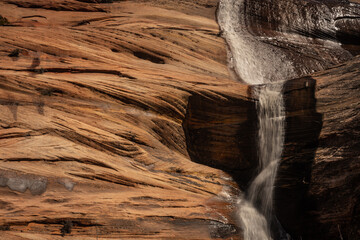 Water Rushes Down The Smooth Sandstone Walls In Zion