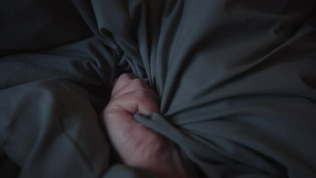 Woman's Hand Squeezing Pillow In Bed During Orgasm. Erotic Concept. closeup shot