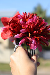 Hand with a red floral headband