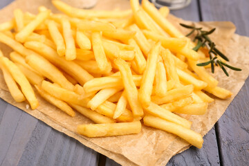Tasty french fries, salt and mayonnaise on blue wooden background