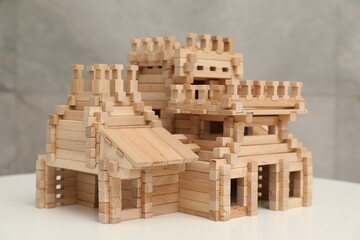 Wooden castle on white table. Children's toy