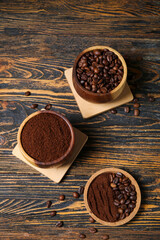Bowls of coffee powder and beans on dark wooden background