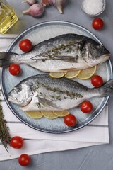 Flat lay composition with raw dorado fish on grey table