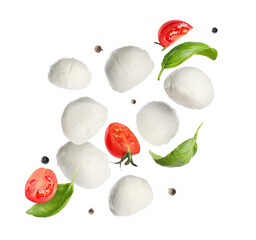 Mozzarella balls, cut tomatoes, basil leaves and peppercorns falling on white background