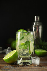 Glass of tasty mojito on table