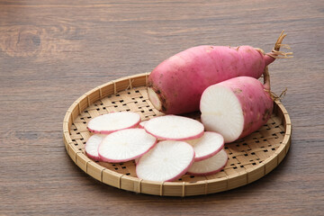 Fresh Red Radish (Lobak Merah) on wooden background.
