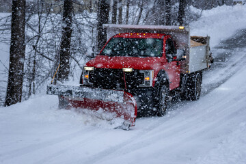 Municipal Snow Plow Truck clearing snow during heavy snowstorm snow falling snow removal