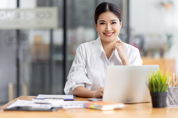 Asian Business woman work in the office. concept of tax, report, accounting, statistics, and...