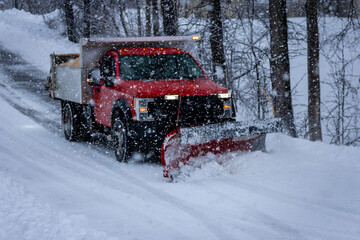 Municipal Snow Plow Truck clearing snow during heavy snowstorm snow falling snow removal
