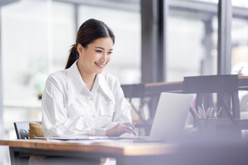 Asian Business woman work in the office. concept of tax, report, accounting, statistics, and analytical research.