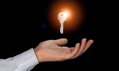 Human hand hold the key to apartment