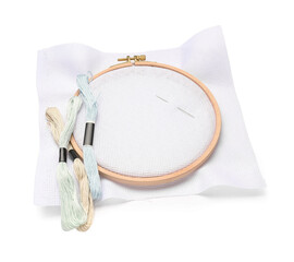 Embroidery hoop with canvas, needle and mouline threads isolated on white background