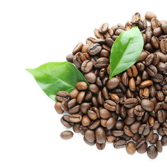 Obraz premium Freshly roasted coffee beans with green leaves, aromatic beverage ingredient for morning drink and cafe culture, this combination represents the natural origin and aromatic quality of coffee