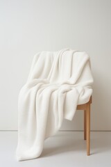A cotton blanket on a minimalist white background  AI generated
