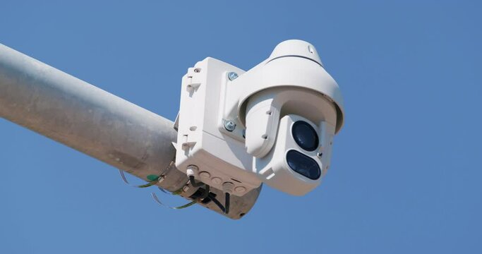 Street surveillance camera operates for safety of park visitors. Street surveillance camera monitors order in city park protecting resort tourists