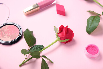 Obraz na płótnie Canvas Composition with makeup products and beautiful red rose flower on pink background, closeup