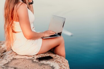 Freelance women sea working on the computer. Good looking middle aged woman typing on a laptop...