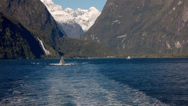 Looking at a Boat and Bowen Falls in the Milford Sounds, New Zealand