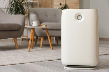 Modern air purifier in interior of living room