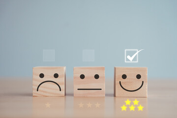 Feedback rating and Customer experience, Mental health assessment, World mental health day, Think positive, Emotion, Satisfaction. Check mark for choose happy face and 5 star on wooden block. - obrazy, fototapety, plakaty