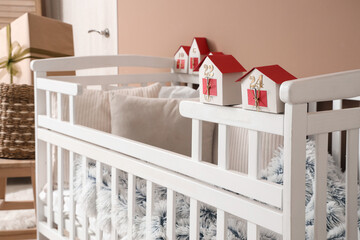 Baby crib with Christmas Advent calendar in children's room, closeup - obrazy, fototapety, plakaty