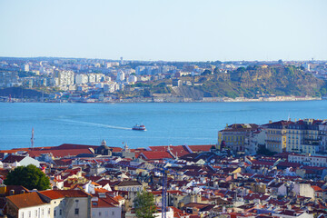 View of Lisbon, Capital city of Portugal with a boat crossing the river