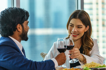 Caucasian woman having dinner with Indian man Inside the restaurant happily