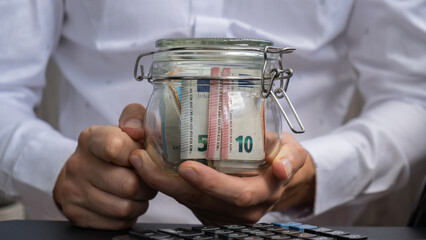 Euro Banknote Saving Money In Glass Jar. Unrecognizable man Moderate Consumption on calculator And Economy Collecting Money Tips Business Finance footage