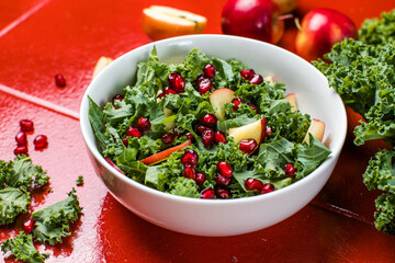 Hokkaido apple and quinoa salad with kale, pomegranate, spring onion and toasted sunflower seeds. Healthy homemade food. Vegan food