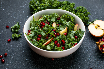 Hokkaido apple and quinoa salad with kale, pomegranate, spring onion and toasted sunflower seeds. Healthy homemade food. Vegan food