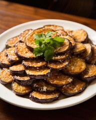 Crispy fried eggplant slices, drizzled with honey and sprinkled with sea salt. The eggplant is lightly breaded and fried to perfection, becoming tender and caramelized on the inside, while