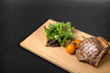 Grilled beef steak with vegetables on the desk