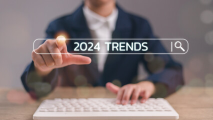Businesswoman touching to search engine bar with 2024 trends wording for marketing monitor and business planning in new year concept.