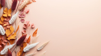A creative arrangement of autumnal dried flowers, leaves, and wheat on a peach background, symbolizing fall harvest and natural decor. - obrazy, fototapety, plakaty