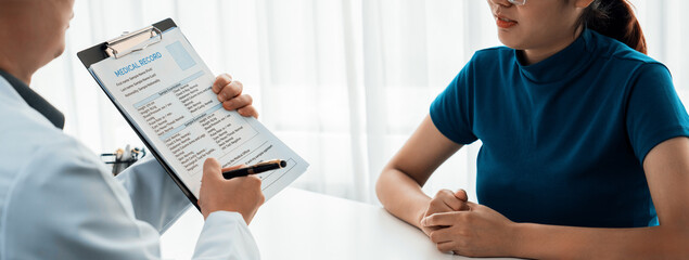 Patient attend doctor's appointment at clinic or hospital office, discussing medical treatment options and explaining examination results or medical record about sickness. Panorama Rigid