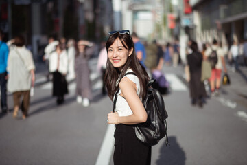Fototapeta na wymiar Urban chic, Trendy young lady in Tokyo, radiating positivity and success, showcasing the dynamic lifestyle of modern Japanese women.