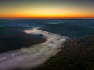 Aerial view of river in the forest at sunrise