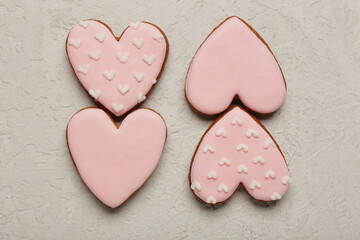 Obraz premium Tasty heart shaped pink cookies on white grunge background. Valentine's Day celebration