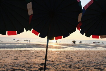 person with umbrella on the beach